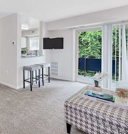 a living room and dining room with a table and chairs