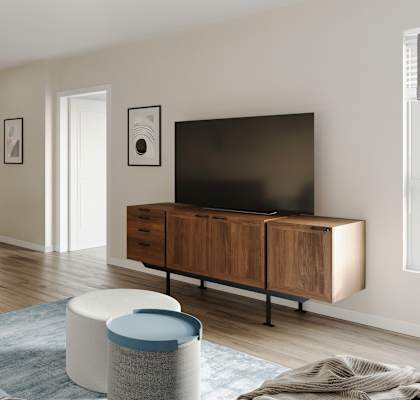 A modern living room with a blue sofa and a television.