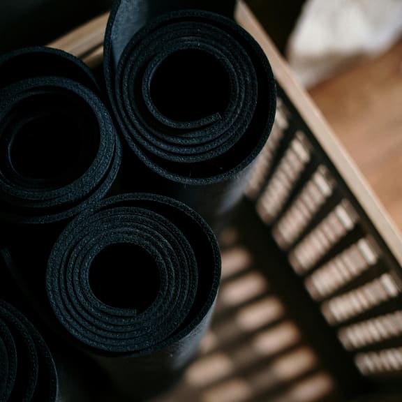 A vibrant yoga mat placed on a floor, inviting serenity and mindfulness.