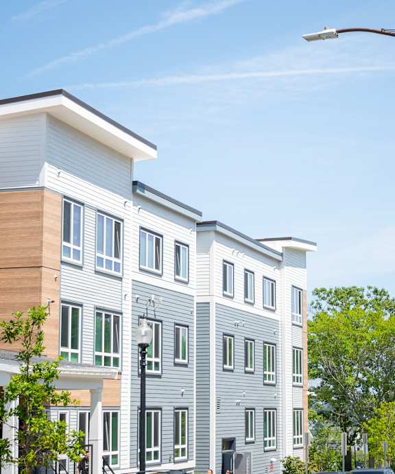 A street view of a residential area with apartment buildings.