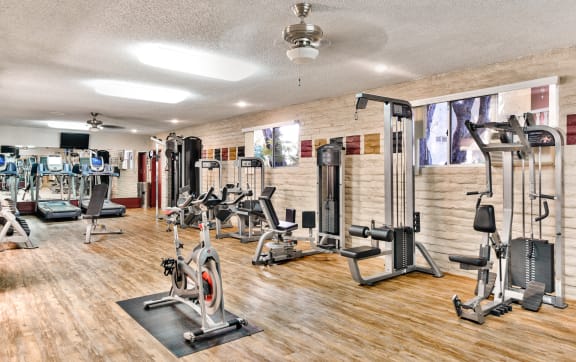 a gym with rows of treadmills and other exercise equipment  at Mediterranean Village West Hollywood, West Hollywood, CA, 90069