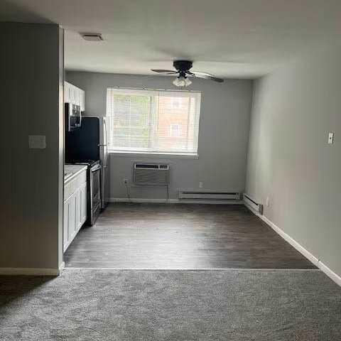 A room with a ceiling fan and a window with blinds.at Manchester Apartments, Pennsylvania
