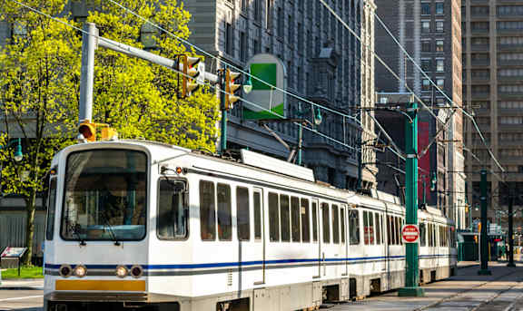 A train is on the tracks in the city at Shoreline Apartments, Buffalo, New York