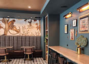 Thumbnail 36 of 53 - A room with a long table and chairs with a mural of a monkey on the wall.