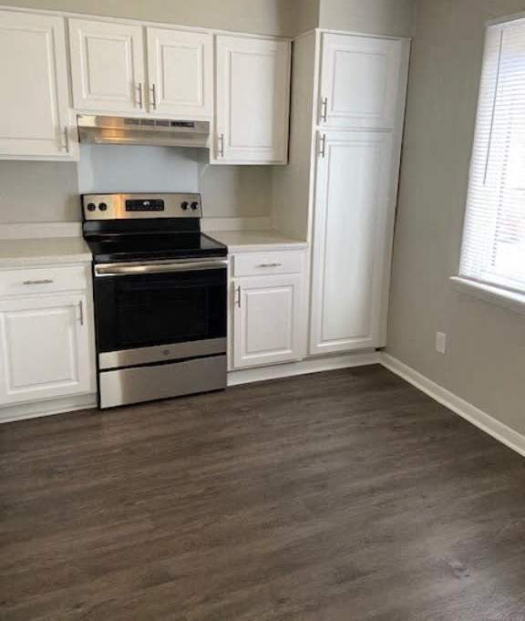 a kitchen with a stove and white cabinets at Colony Townhomes, Raleigh, 27609