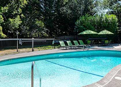 a resort style swimming pool in front of a house