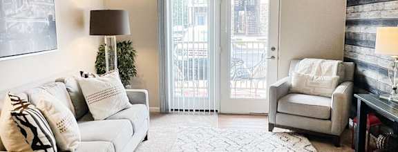 a living room with a couch and a table  at The Residences at Liberty Crossing, Columbus, OH