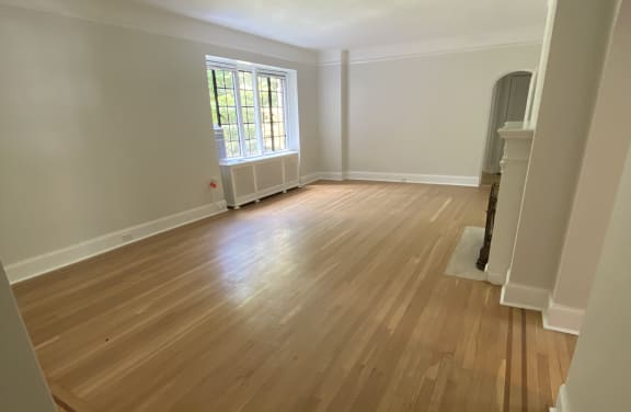 a view from the top of the stairs looking down at the hardwood flooring and a