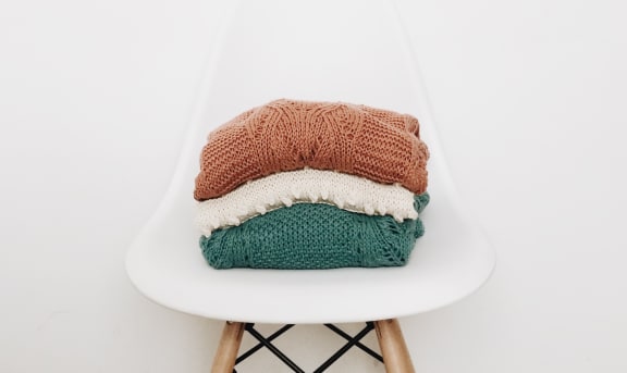 Folded laundry on white chair