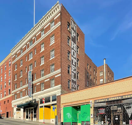 A large red brick building with the words "NY PYTHON HOTEL" on the side.