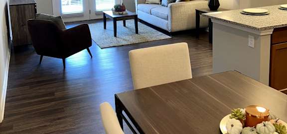 a view of a living room and dining room from the kitchen of an apartment