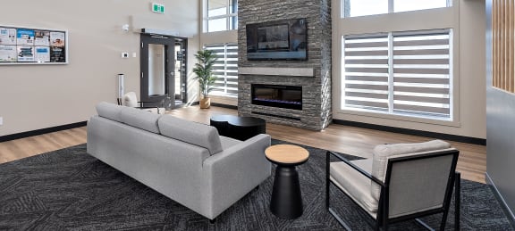 a living room with a gray couch and a fireplace