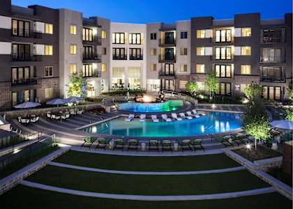 Centric One90 Apartments in Plano, Texas Pool with Lounge Chairs at Dusk