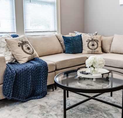 a living room with couches and a coffee table in front of a window