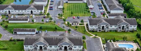 A bird's eye view of a residential area with houses and a road.