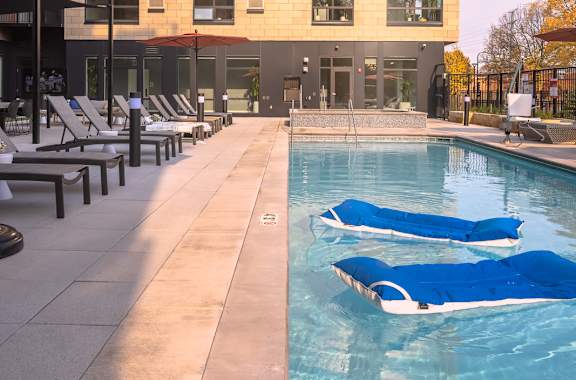 A modern building with a pool in front.