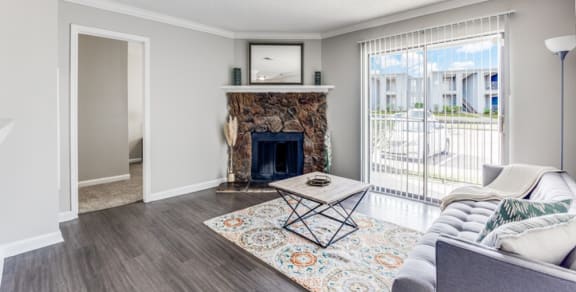 a living room with a fireplace and a sliding glass door