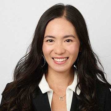 a woman wearing a suit and a necklace