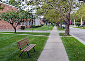 Thumbnail 6 of 28 - Beautiful Paths with Benches at Green Acres Apartments,Saginaw Michigan