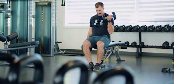 A man is working out in a gym.