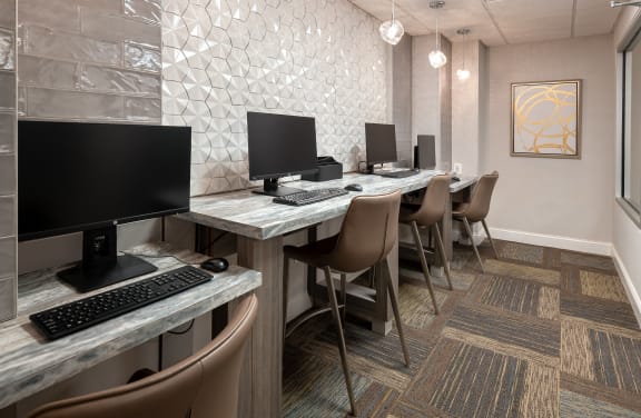 a computer room with a row of desks and chairs