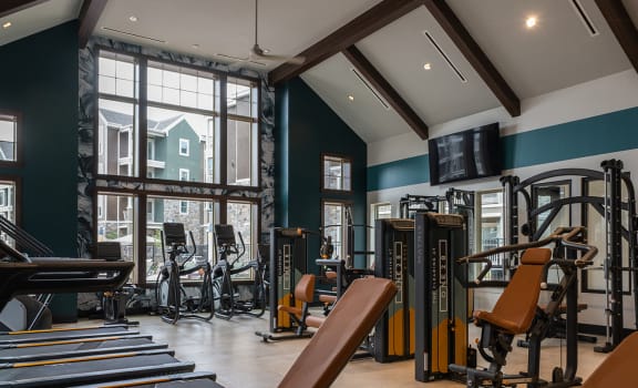 a gym with treadmills and other exercise equipment at The Clearing at ONE28, Olathe
