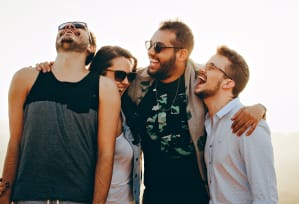 a group of people standing next to each other with their arms around each other