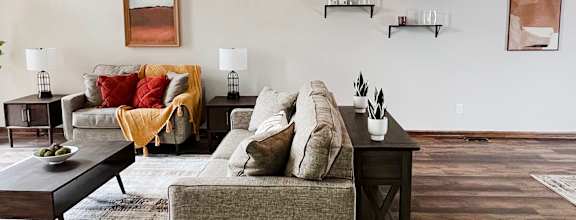 a living room with a couch and a table at Crown Ridge Apartments, Franklin, 45005