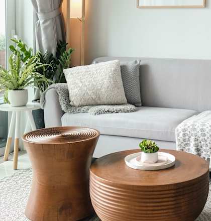 a living room with a grey couch and two coffee tables