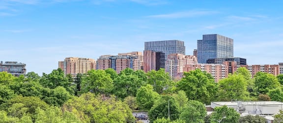 the view of the city from the balcony of a hotel room with a balcony railing