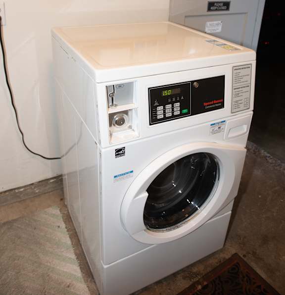 A white washing machine with a digital display and control panel.