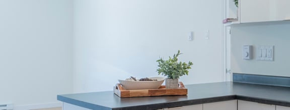 A modern dining room with a wooden table and chairs.