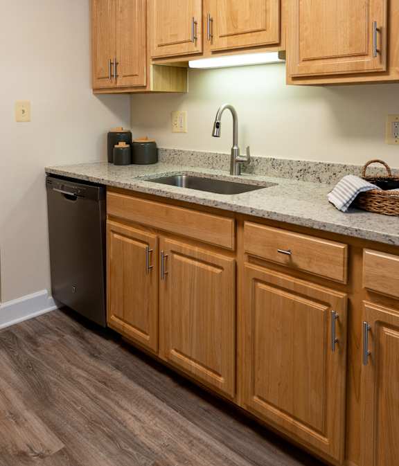 A kitchen with wooden cabinets and a granite countertop  at Ivy Hall Apartments*, Maryland, 21204