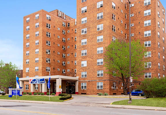 a tall brick building on the corner of a street