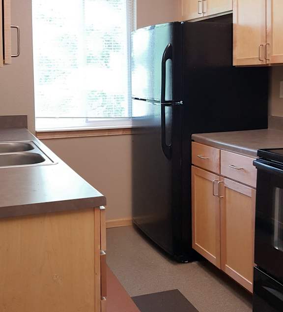 a living room and kitchen with a couch and a table