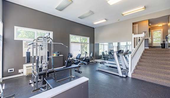 A spacious home gym with a variety of equipment.