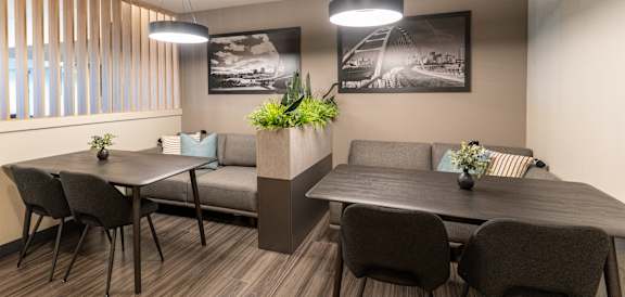 A modern dining area with a table, chairs, and a couch.at Vista Apartments at Edgemont, Edmonton, T6M 1J4