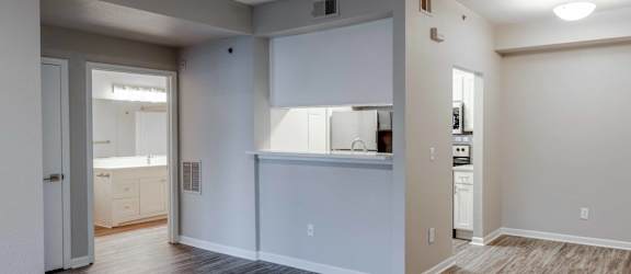 the living room and kitchen of a new home with wood flooring