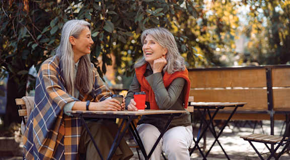 two women sitting at a table talking and laughing at The Carillon, Greensboro, NC