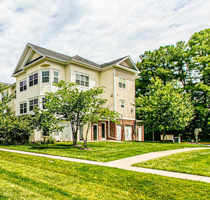 A grassy area in front of apartment buildings. at Barrington Park Apartments, Manassas
