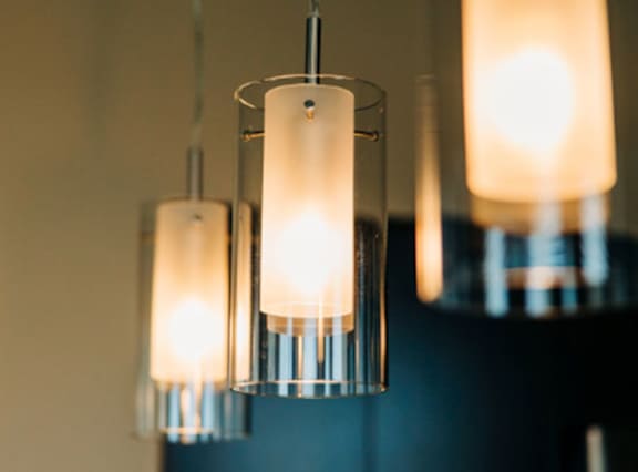 Three hanging lights with a warm glow.