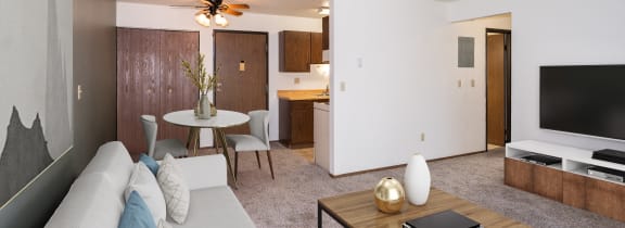 a living room with a couch and a coffee table. Fargo, ND Pacific Park 2 Apartments