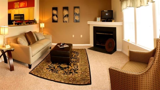 a living room filled with furniture and a fire place at Chester Village Green Apartments, Virginia