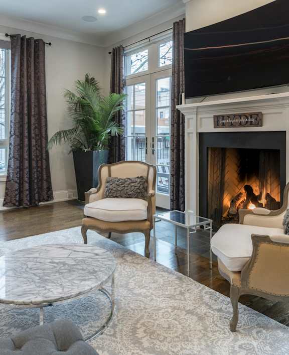 a living room with a fireplace and a television
