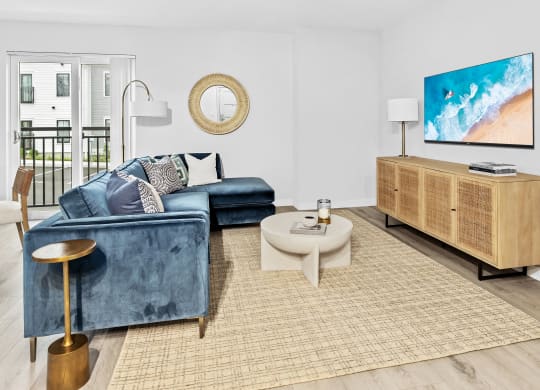 a living room with a blue couch and a tv