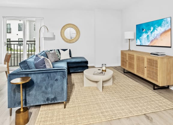 a living room with a blue couch and a tv