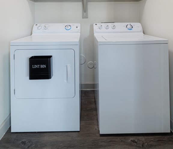 a washer and dryer in a laundry room with shelves