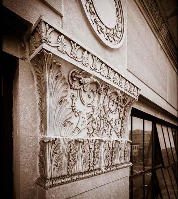 an ornate pillar on the side of a building