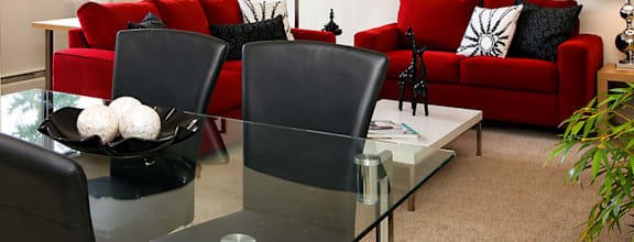 A modern dining room with a wooden table and chairs.
