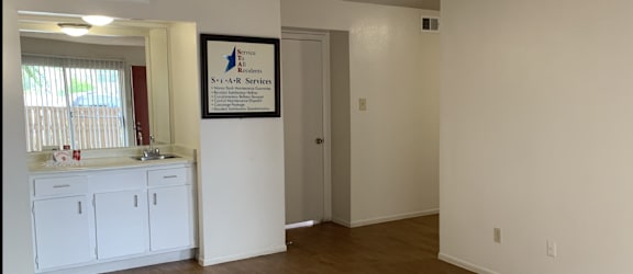 a view of the kitchen and living room of a 560 square foot, 1 bedroom apartment at